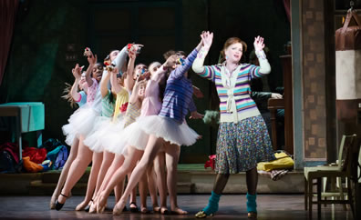 Leah Hocking in dance exercise dress and leggings at the head of a line of her ballet school girls