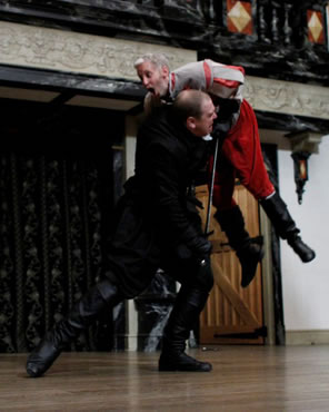 Richard in black stabs Somerset in red and is lifting him overhead with the sword.